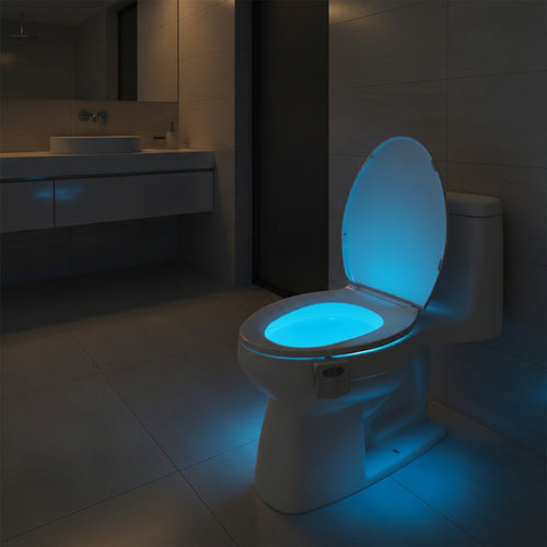 Toilet bowl glowing teal in a dark bathroom, the only light in the room