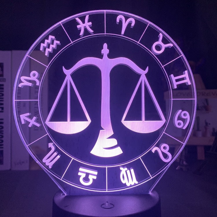 Libra scales engraved on the acrylic zodiac night light, lit violet