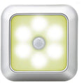 The puck light lit warm, showing its six LEDs around the central motion sensor