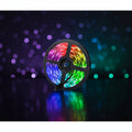 RGB LED strip on the reel, lit through pink, orange, green and blue