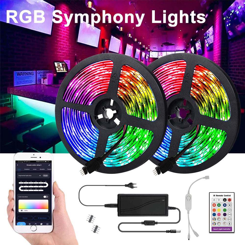 RGB strip lighting a room in deep pink and green, with the remote and mains adapter