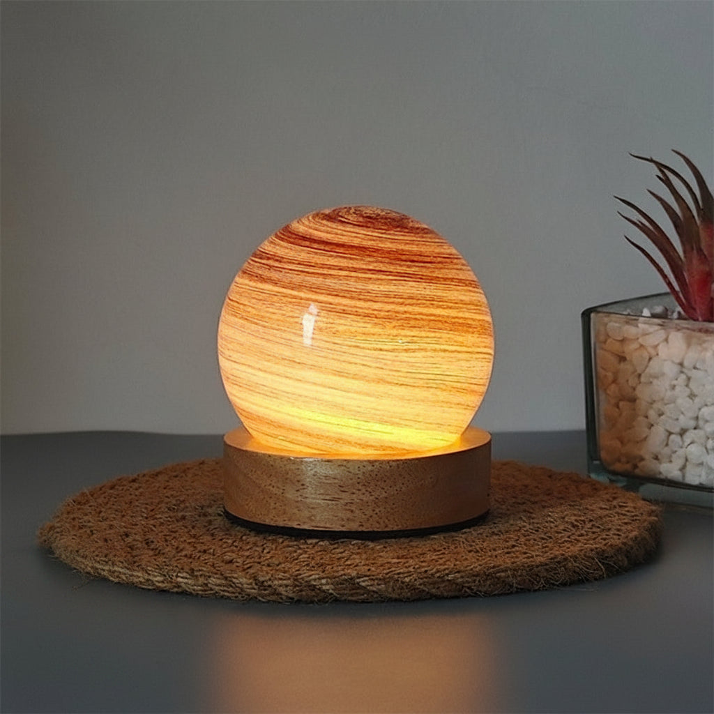 Planet night light in Purple Cloud, a marbled glass globe lit warm on a wooden base