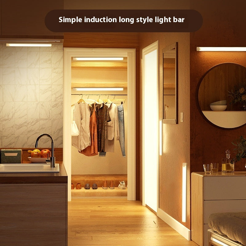 Light bars lit in a kitchen, a wardrobe, a hallway and beside a bed at night