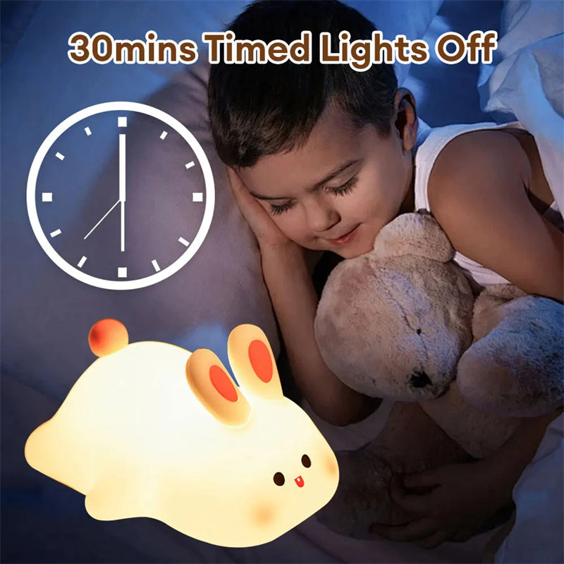 A child asleep beside the lit rabbit light, illustrating the 30 minute sleep timer